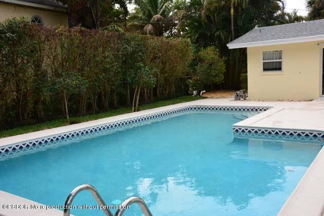 220 Puritan Road West Palm Beach, FL 33405 - Photo 3 of 10 a view of a swimming pool with a backyard