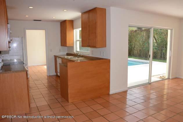 220 Puritan Road West Palm Beach, FL 33405 - Photo 5 of 10 a kitchen with stainless steel appliances granite countertop a refrigerator and a stove