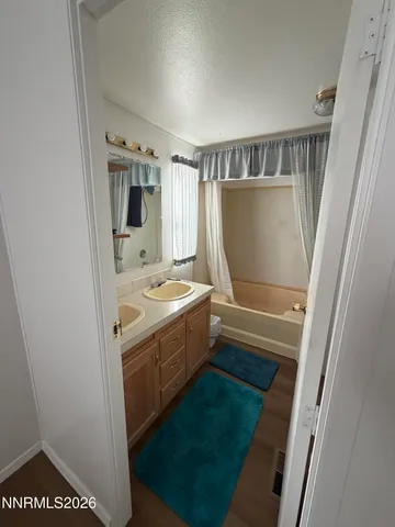 a bathroom with a sink toilet and mirror