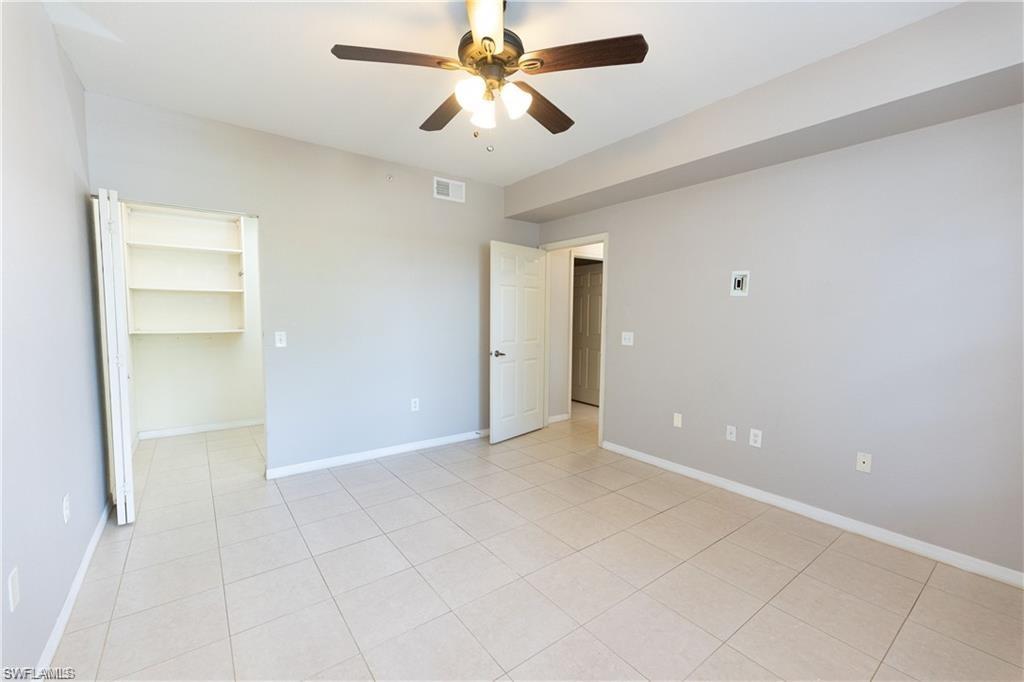 7975 Preserve Circle, Unit 1013 Naples, FL 34119 - Photo 11 of 16 an empty room with closet and a ceiling fan