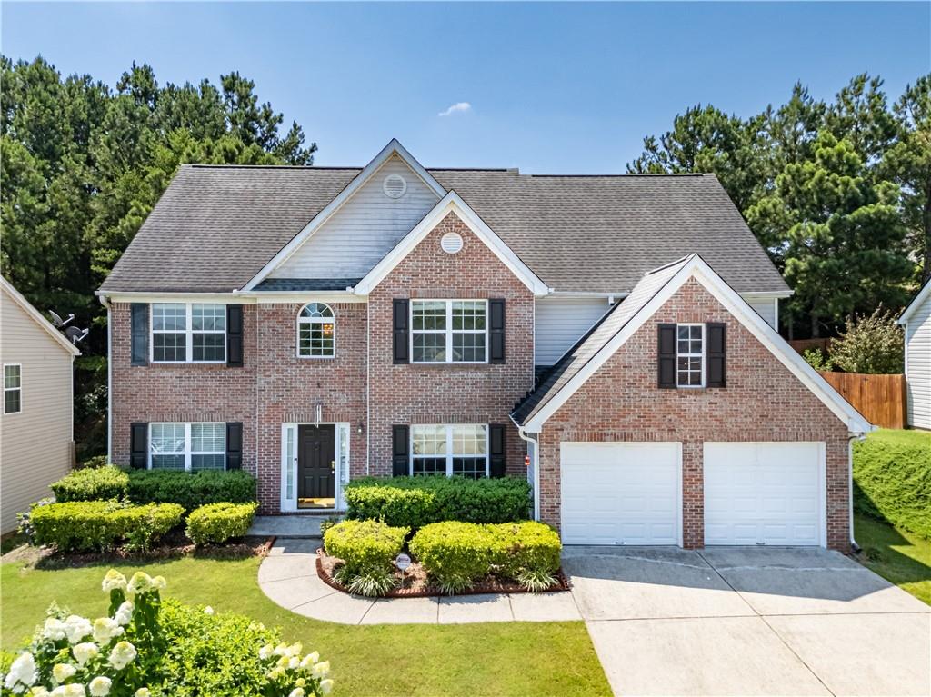 665 Roxford Lane Northeast Buford, GA 30518 - Photo 1 of 19 a front view of a house with a yard and potted plants