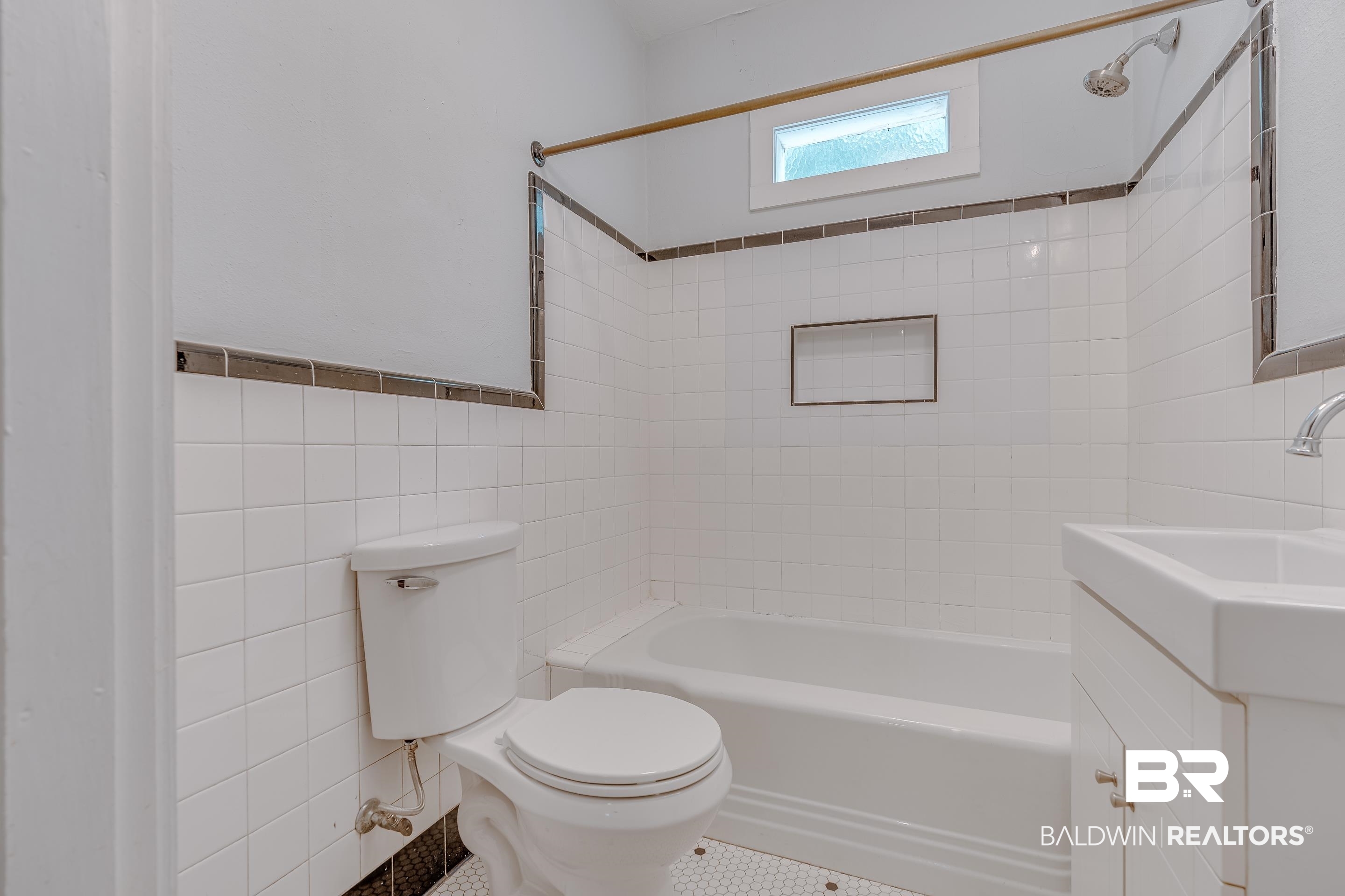 1852 Old Shell Road Mobile, AL 36607 - Photo 15 of 26 Bathroom with tile walls, vanity, shower / bath combination, and a wainscoted wall