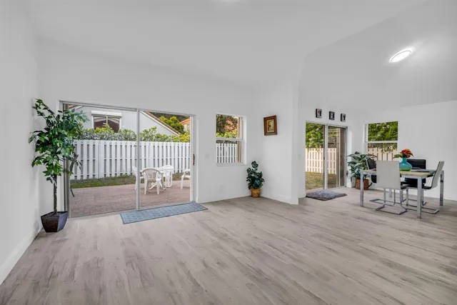 a kitchen with stainless steel appliances granite countertop a stove a dining table and chairs