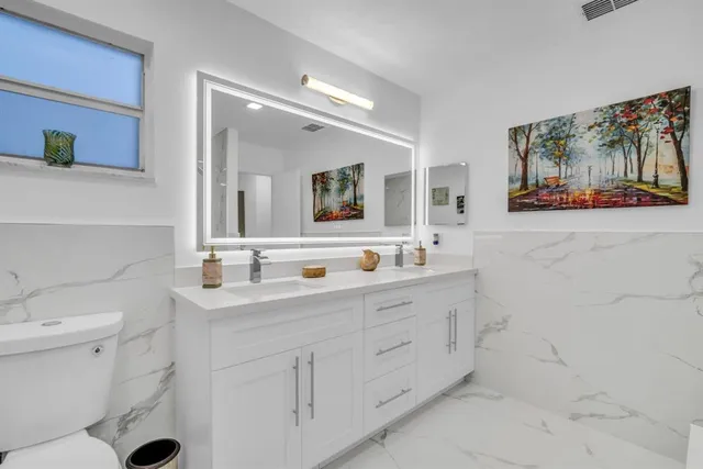 a view of a house with backyard sitting area and garden