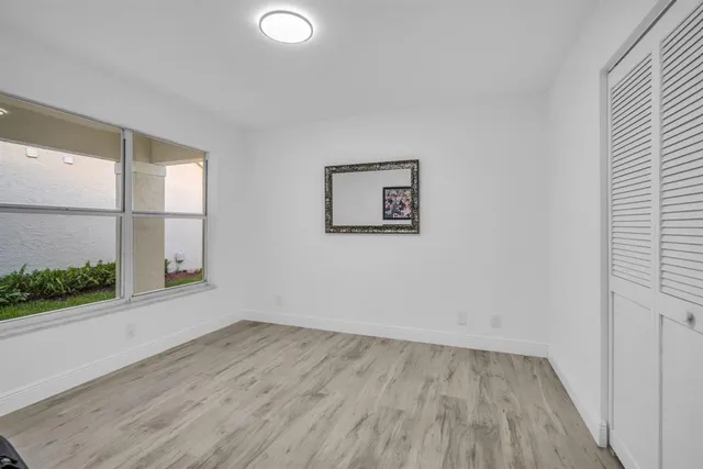 a view of a patio with table and chairs and wooden fence