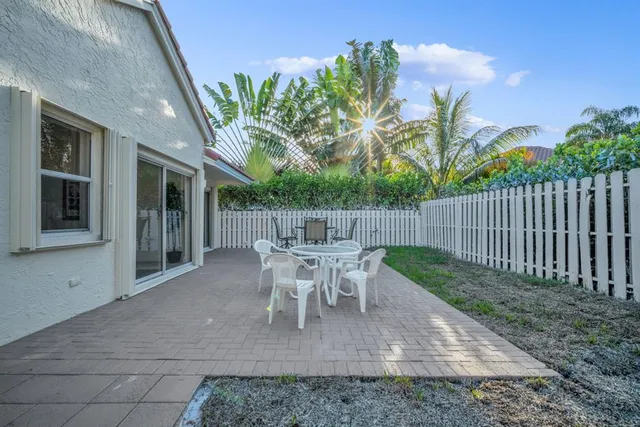 a view of a house with backyard and sitting area