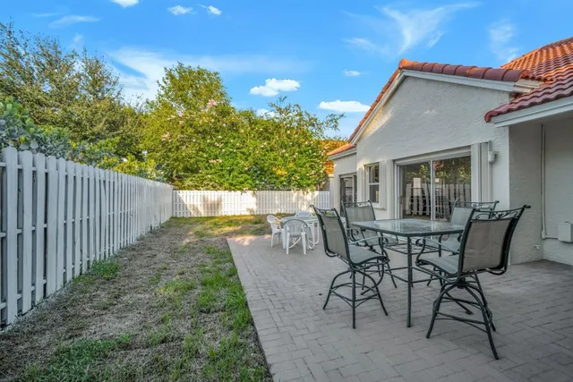 a aerial view of a house with a yard and outdoor seating