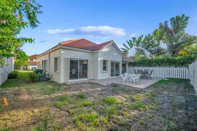 an aerial view of residential house with outdoor space and trees all around