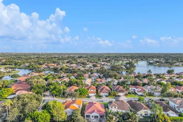 an aerial view of lake and residential houses with outdoor space