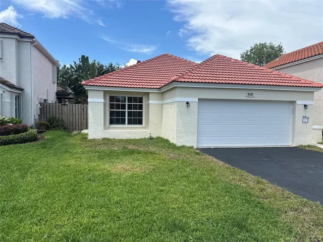 a front view of a house with a yard and garage