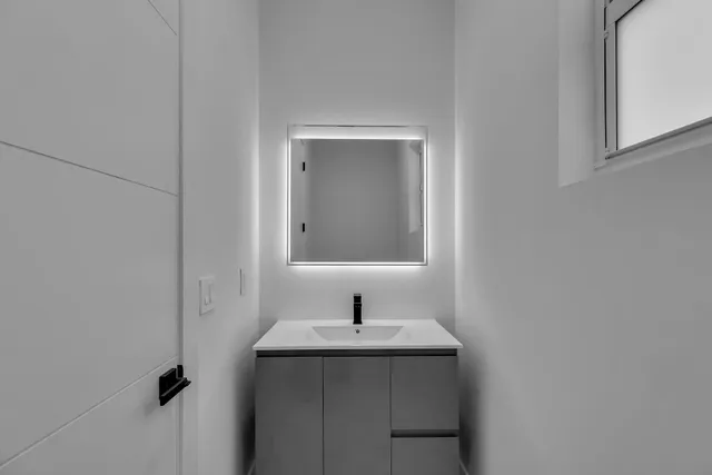 a bathroom with a sink and mirror