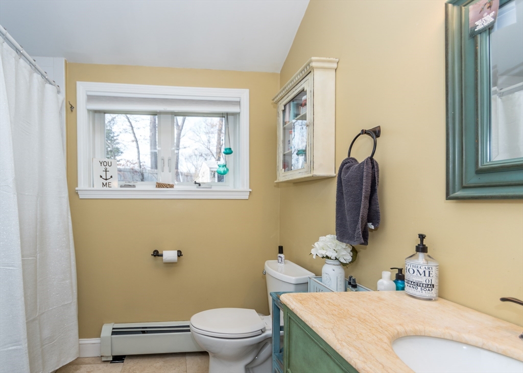 27 Sherman Street Needham, MA 02494 - Photo 14 of 32 a bathroom with a toilet sink and mirror