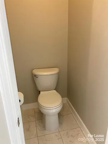 a white toilet sitting next to a shower