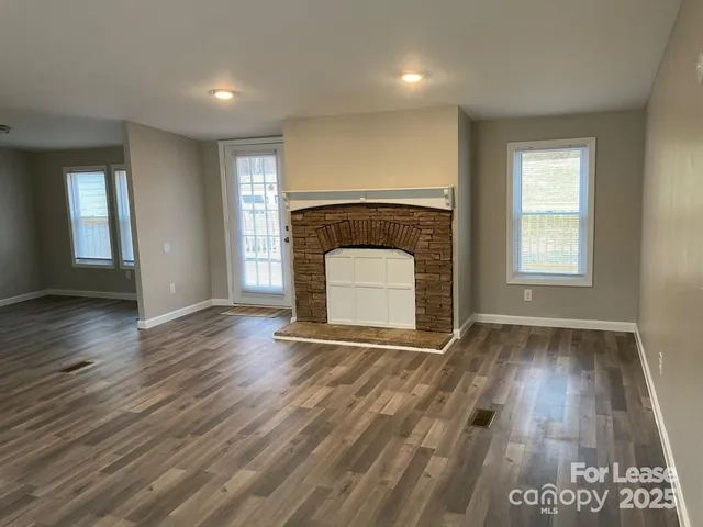 an empty room with wooden floor and a window