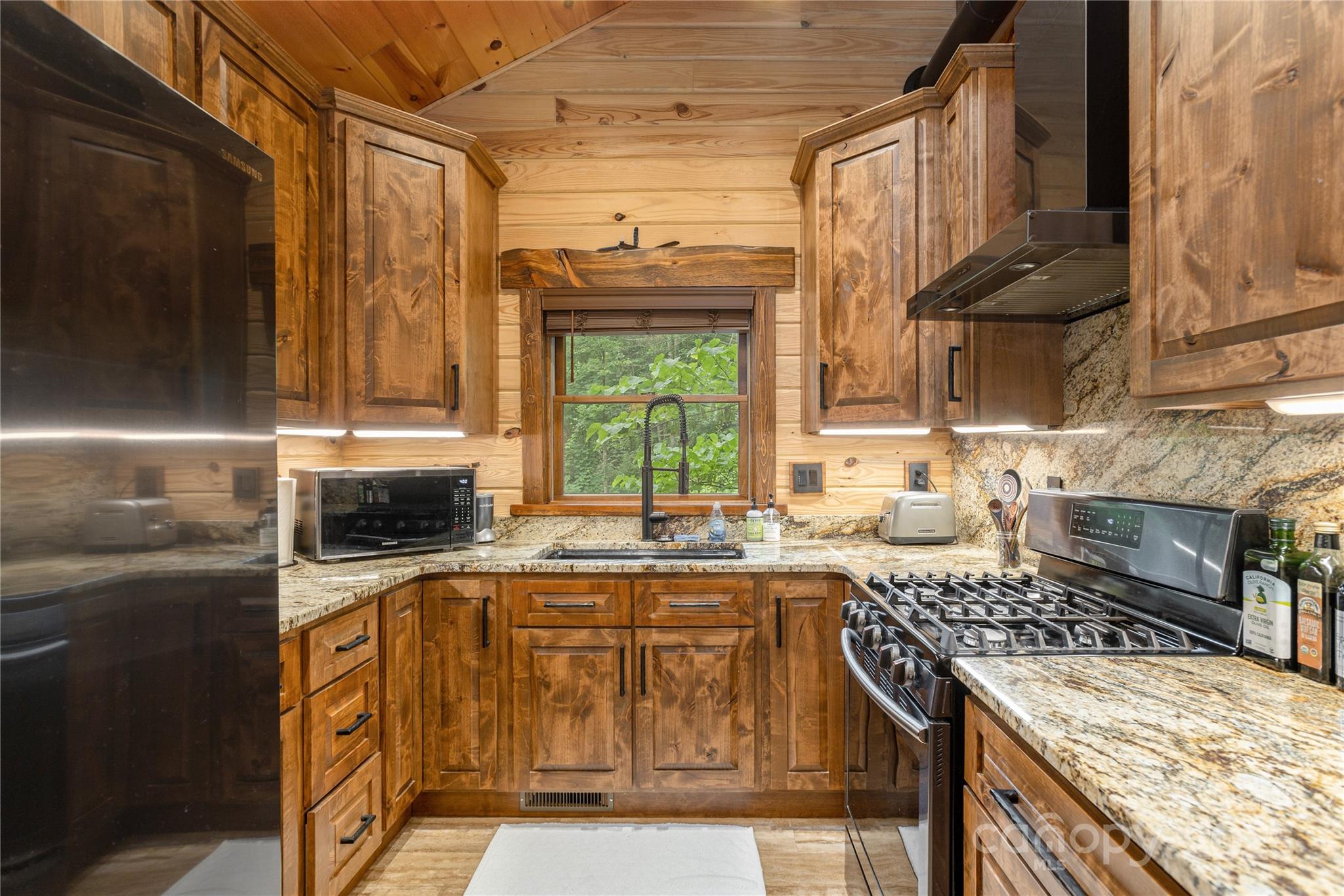 458 Rio Verde Drive Zirconia, NC 28790 - Photo 15 of 34 a kitchen with a stove a sink and a refrigerator