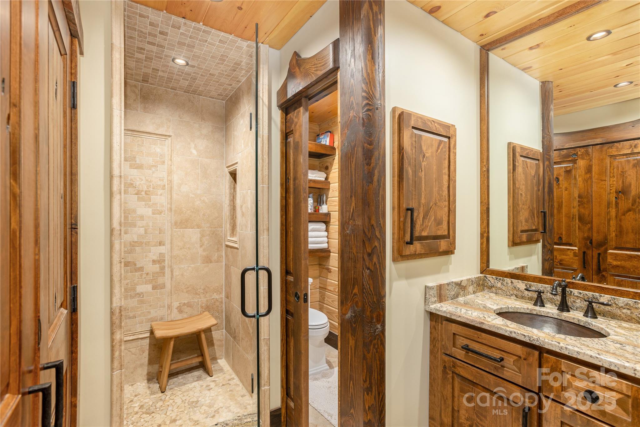 458 Rio Verde Drive Zirconia, NC 28790 - Photo 16 of 34 a bathroom with a granite countertop sink a mirror and a shower