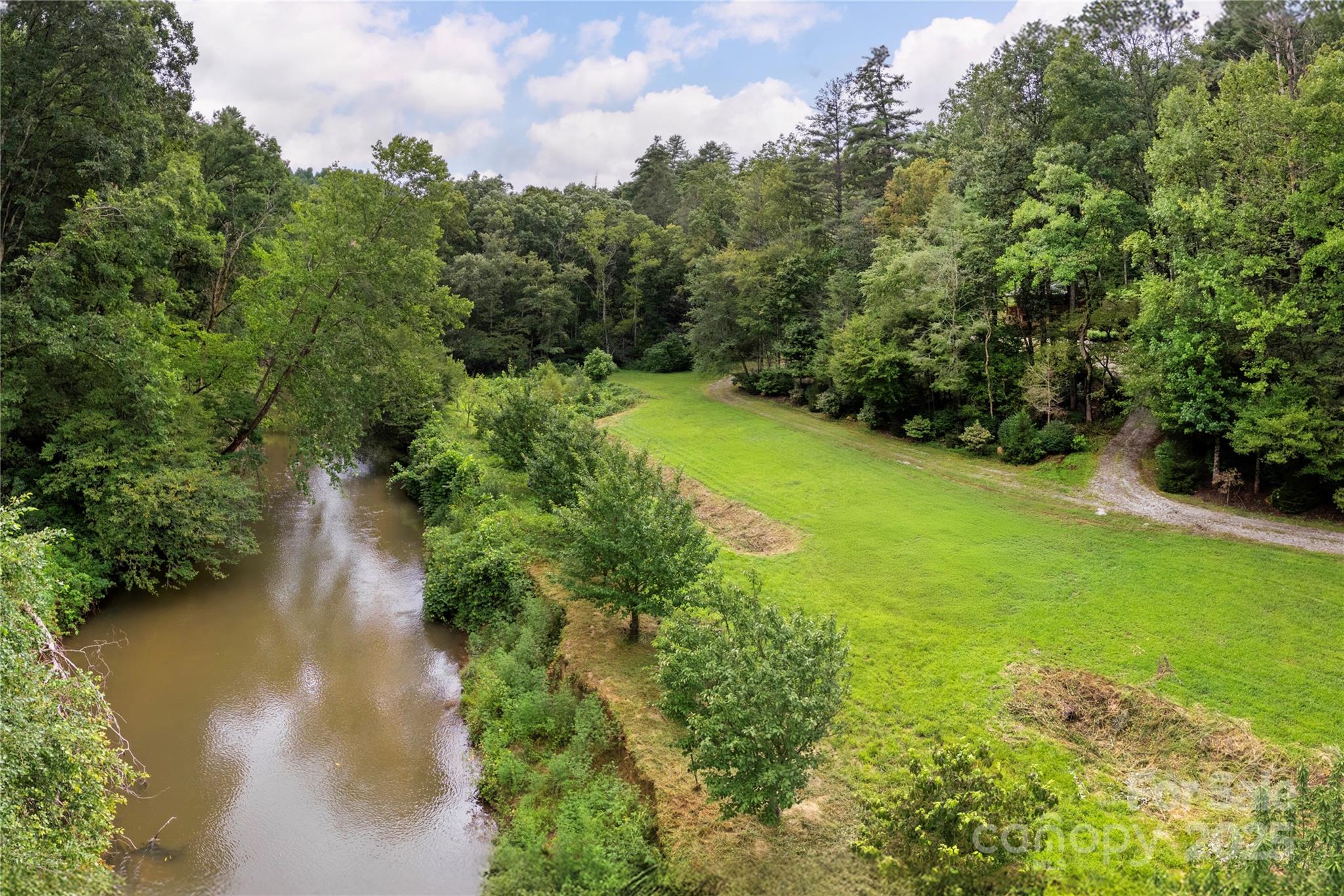 458 Rio Verde Drive Zirconia, NC 28790 - Photo 21 of 34 a view of a garden with a building in the background