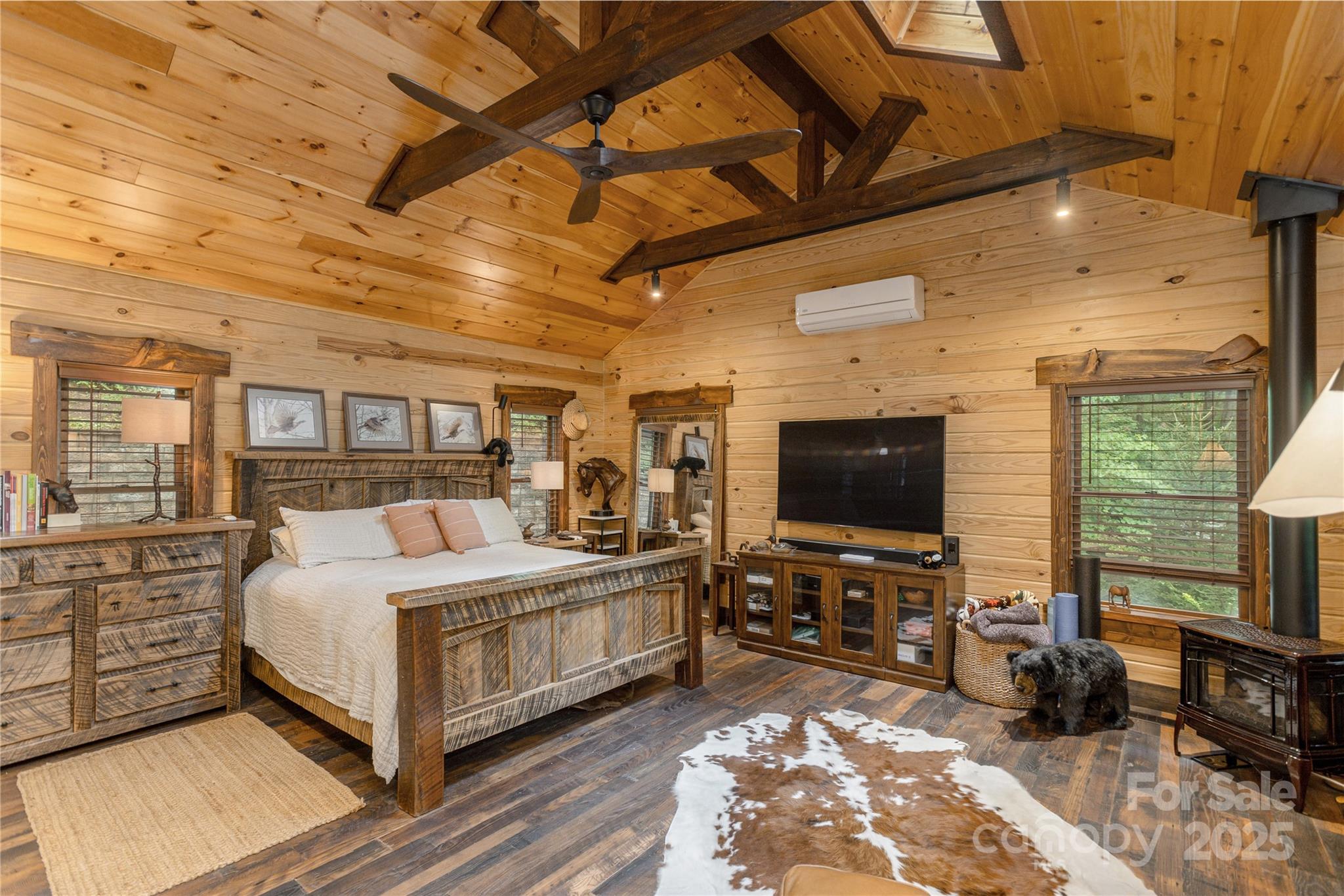 458 Rio Verde Drive Zirconia, NC 28790 - Photo 9 of 34 a bedroom with a bed a flat screen tv and a chandelier