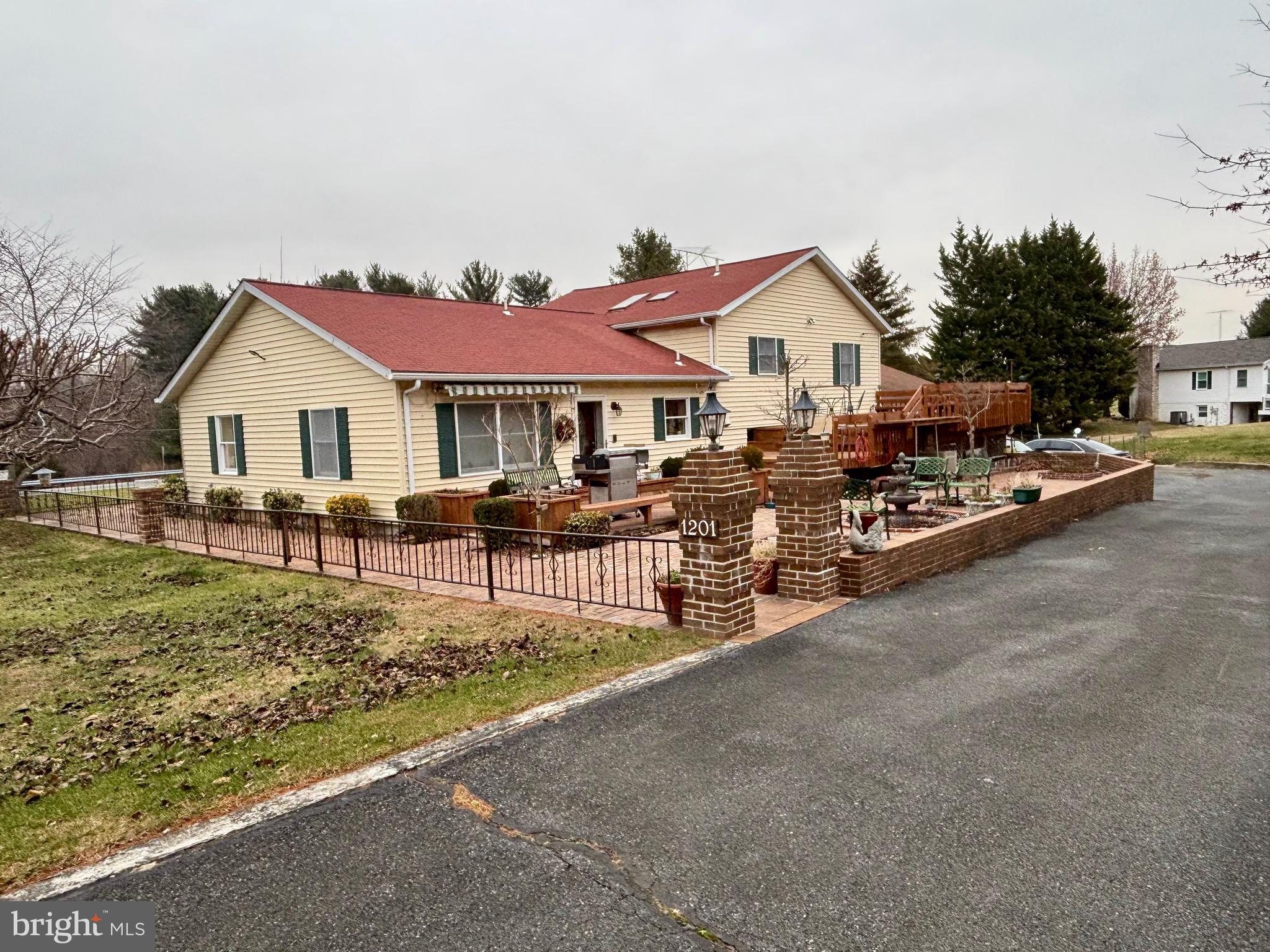 1201 Uniontown Road Westminster, MD 21158 - Photo 3 of 7 a front view of a house with a yard and garage