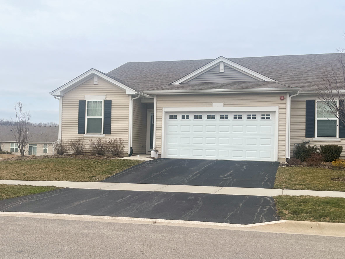 283 Ridley Street North Aurora, IL 60542 - Photo 1 of 40 a front view of a house with a yard and garage