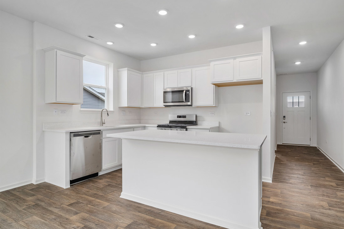 283 Ridley Street North Aurora, IL 60542 - Photo 5 of 40 a kitchen with stainless steel appliances granite countertop a sink stove and refrigerator