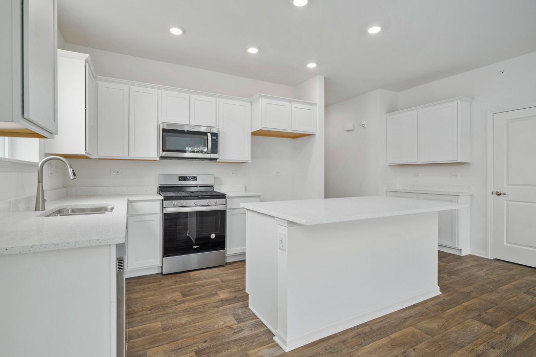 283 Ridley Street North Aurora, IL 60542 - Photo 6 of 40 a kitchen with stainless steel appliances a stove sink and microwave