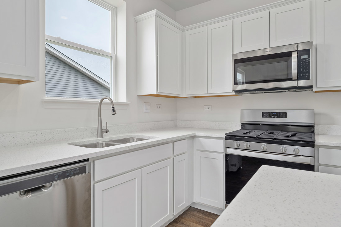 283 Ridley Street North Aurora, IL 60542 - Photo 7 of 40 a kitchen with stainless steel appliances granite countertop a sink stove and microwave