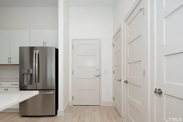 a view of hallway with stainless steel appliances