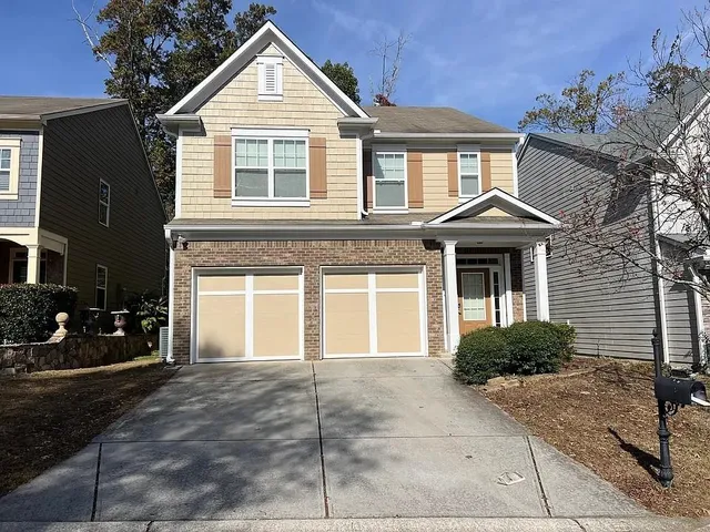 a front view of a house with garden