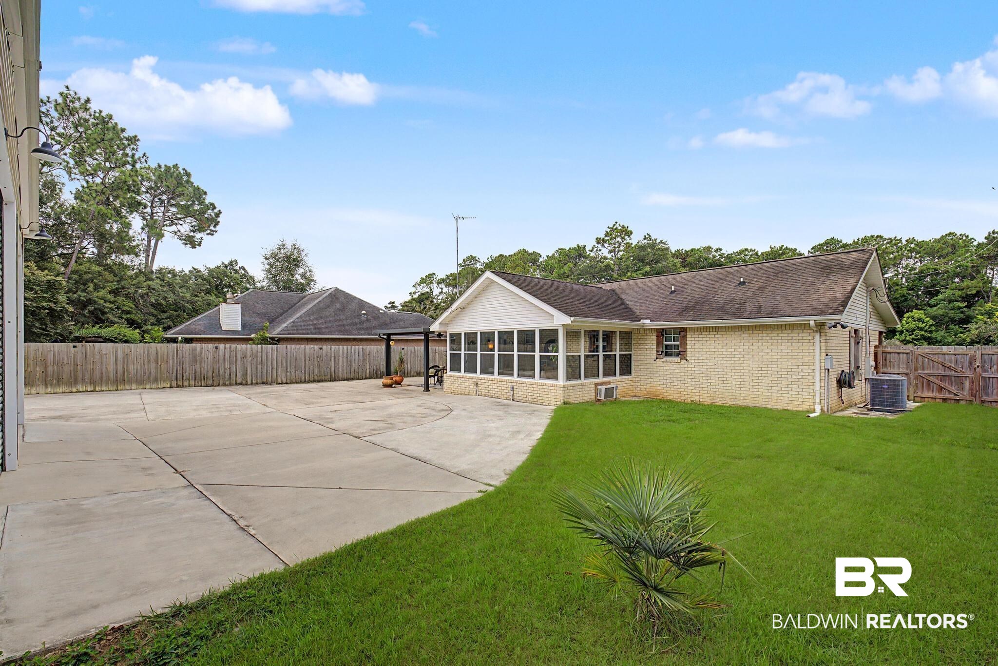 2808 Pine Ridge Drive Lillian, AL 36549 - Photo 26 of 47 Expansive concrete driveway and patio area alongside a manicured lawn