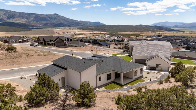 2862 South Mountain Rnch Road Cedar City, UT 84720 - Photo 60 of 64 Contemporary residence featuring a covered patio, landscaped terraced yard, and a two-car garage