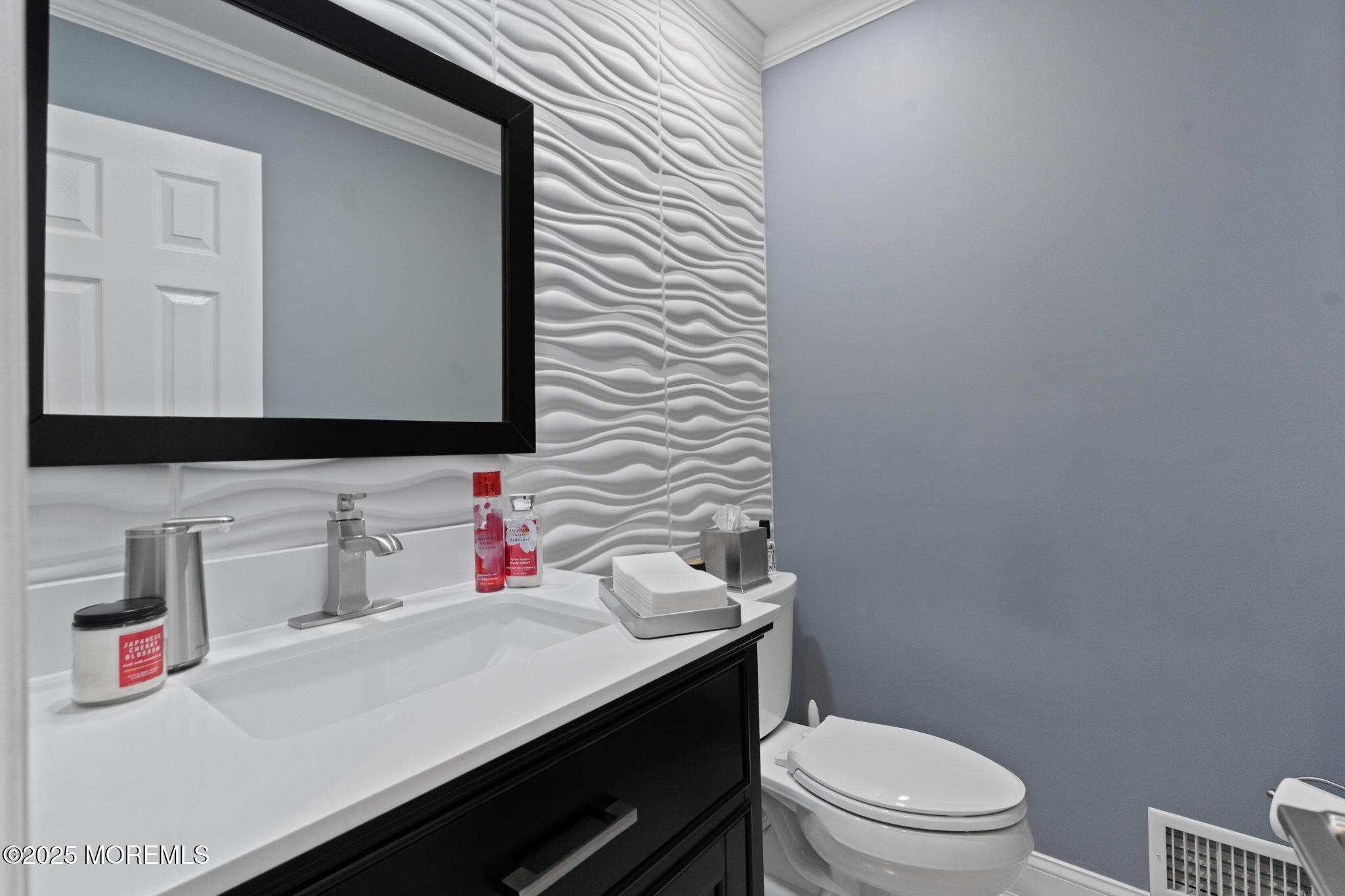 93 Wallace Road Middletown, NJ 07748 - Photo 15 of 47 a bathroom with a sink vanity mirror and toilet