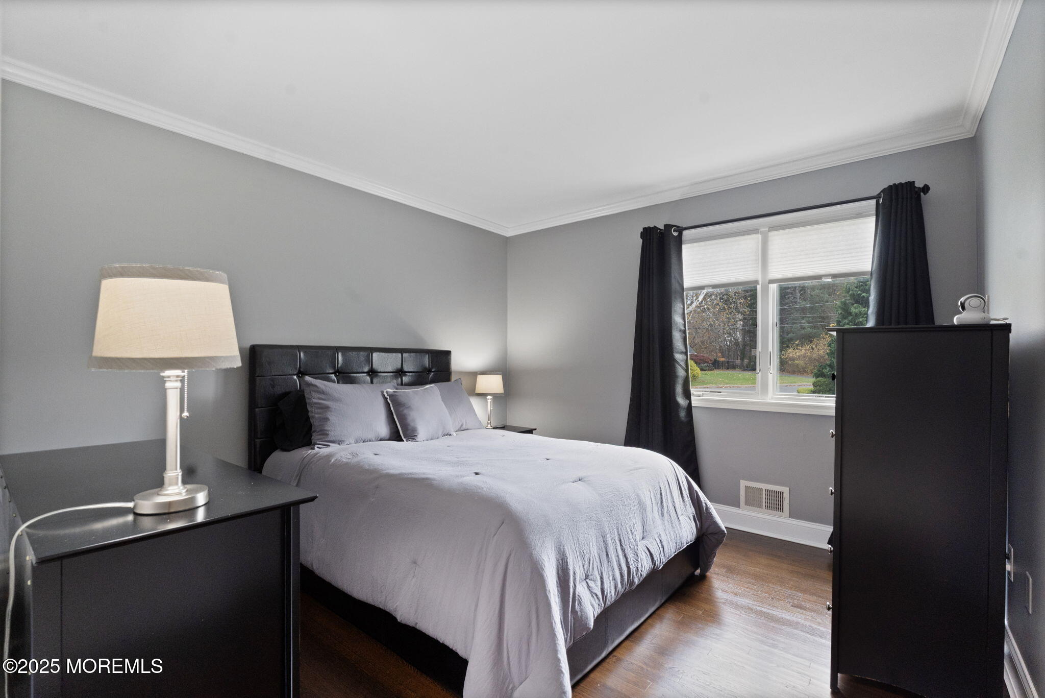 93 Wallace Road Middletown, NJ 07748 - Photo 24 of 47 a bedroom with a bed and a lamp