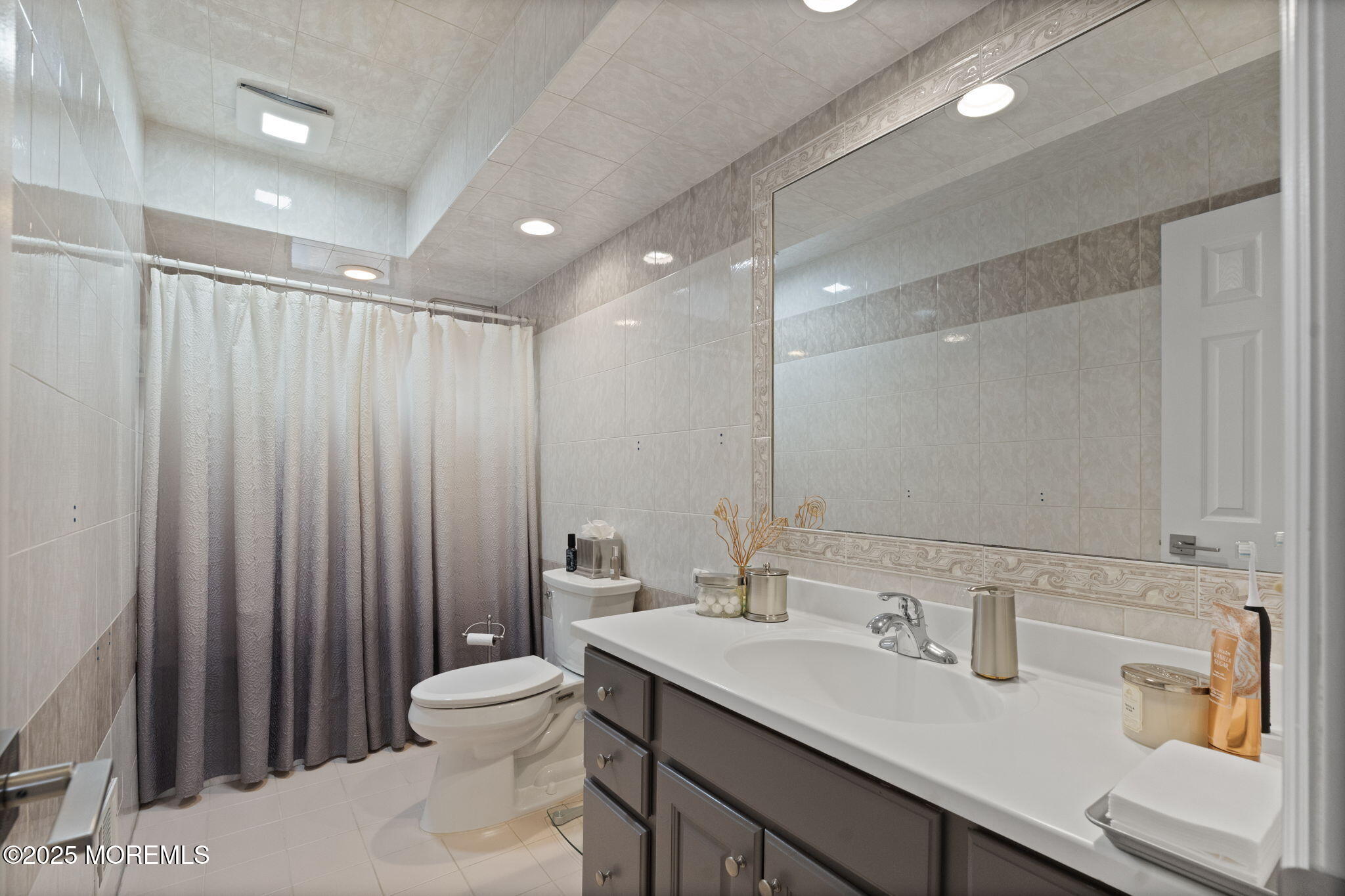93 Wallace Road Middletown, NJ 07748 - Photo 25 of 47 a bathroom with a double vanity sink toilet and a mirror