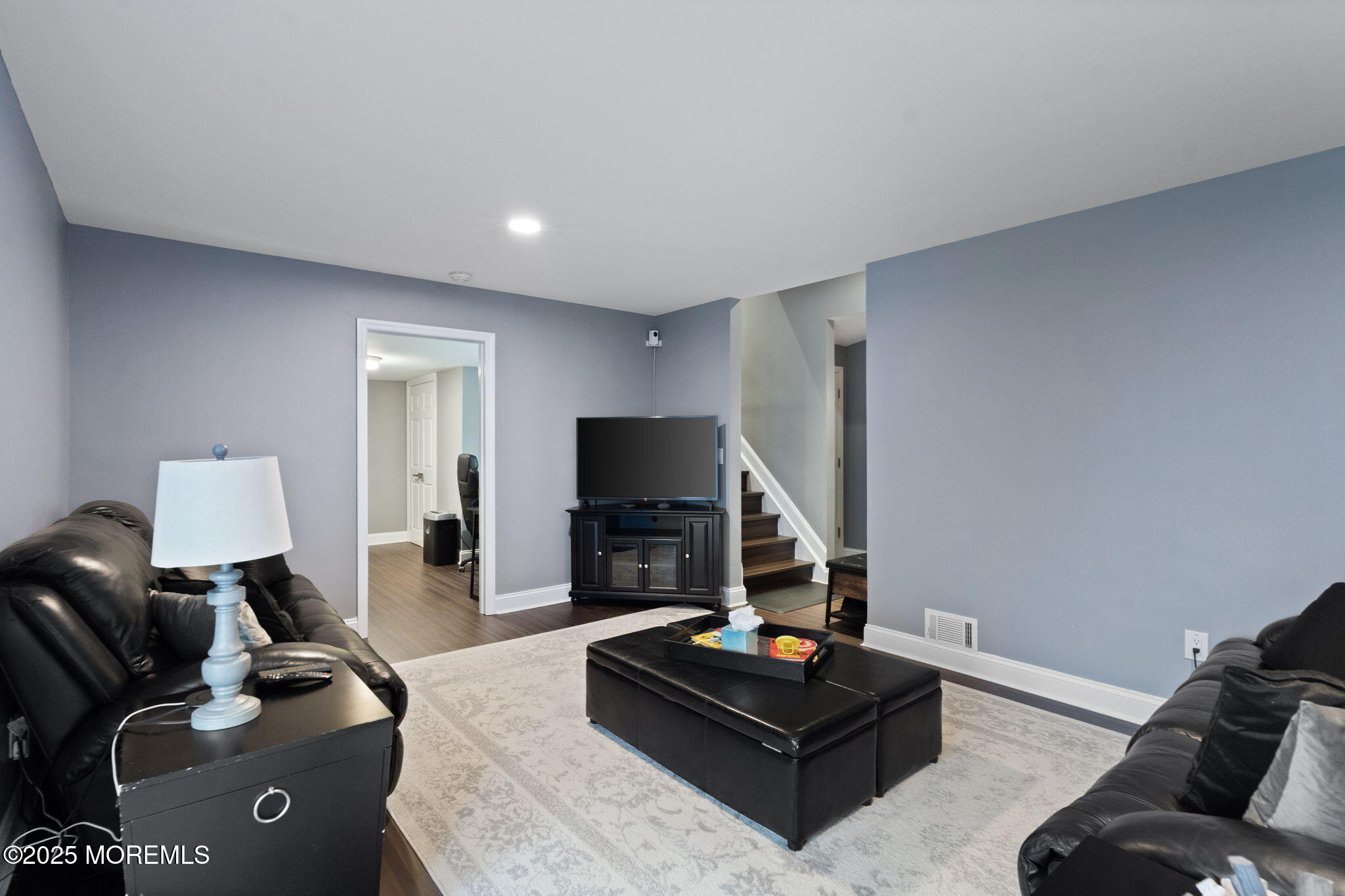 93 Wallace Road Middletown, NJ 07748 - Photo 27 of 47 a living room with furniture a fireplace and a flat screen tv