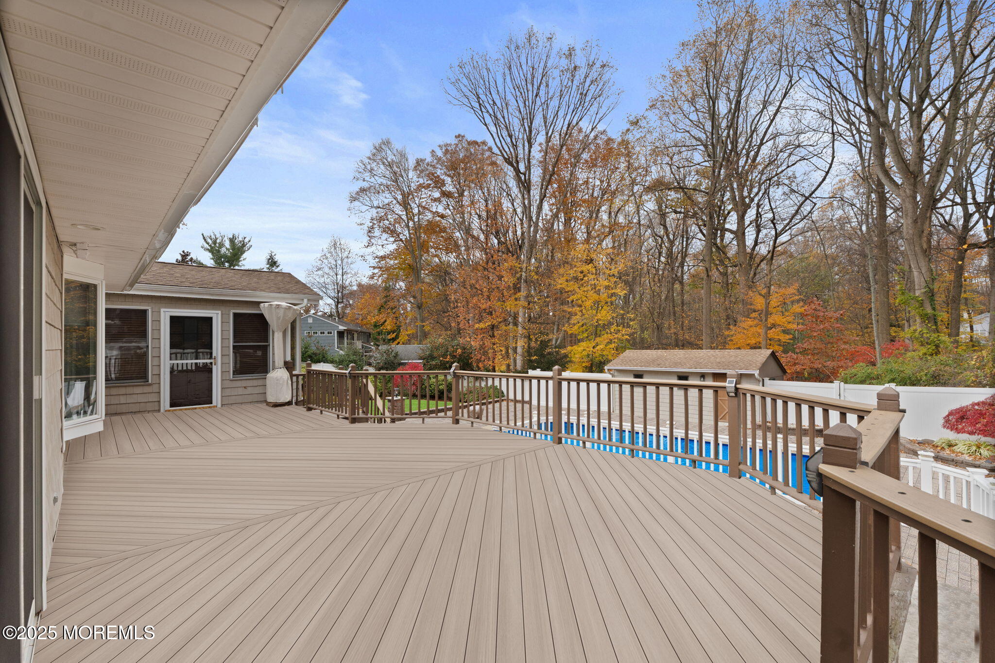 93 Wallace Road Middletown, NJ 07748 - Photo 36 of 47 a view of a house with wooden deck and trees