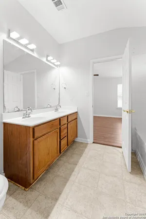 a spacious bathroom with a sink a mirror and a bathtub