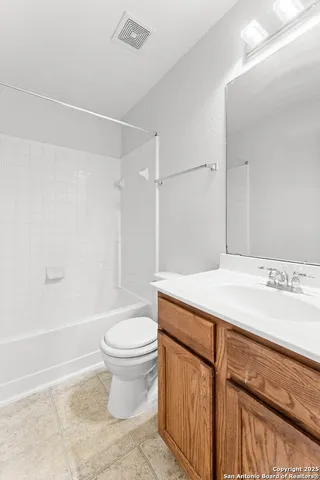 a bathroom with a sink a toilet and a shower