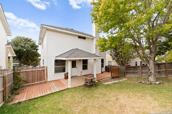 a view of a house with a backyard