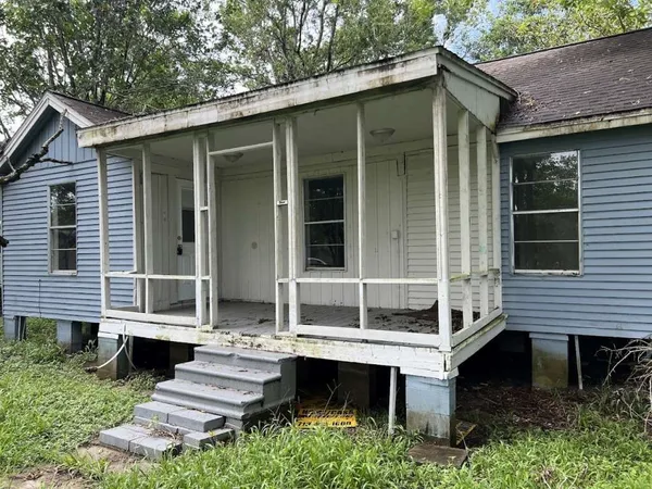 a view of house with a yard and sitting area