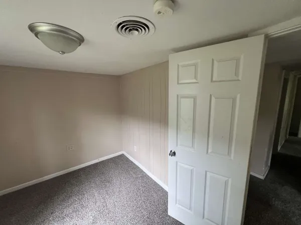 an empty room with wooden floor