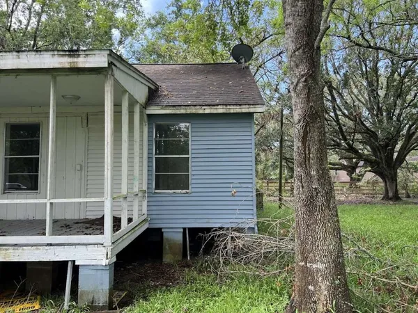 a view of a house with a yard and tree s