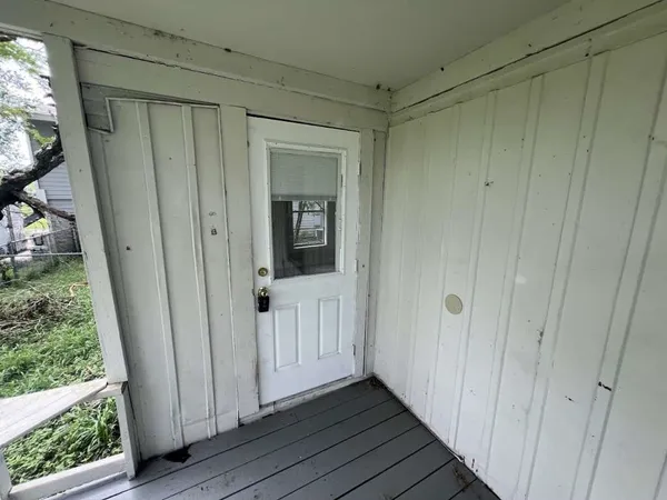 a view of a hallway with wooden floor and entryway