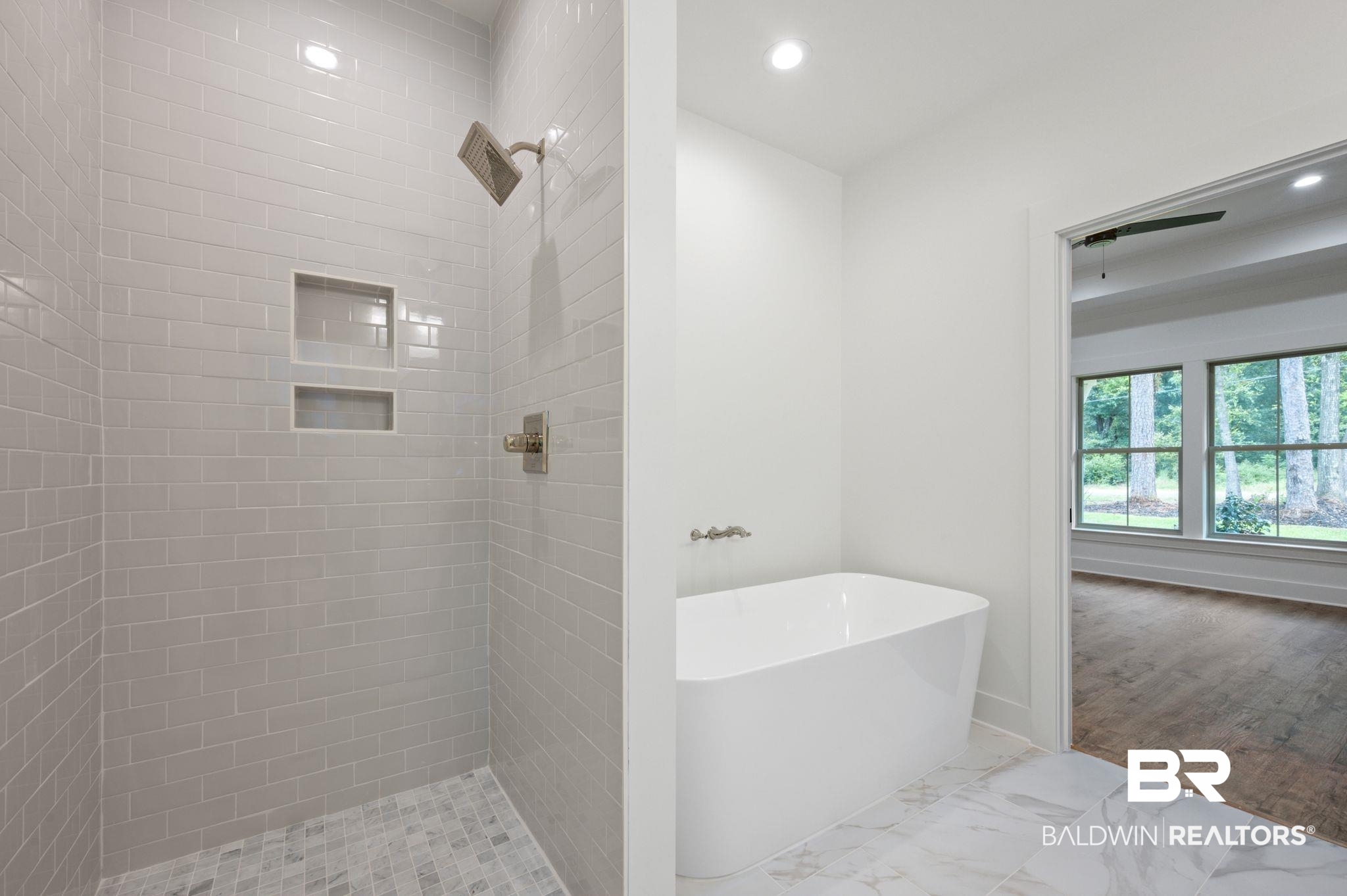 12412 Mannich Lane Foley, AL 36535 - Photo 15 of 23 Bathroom featuring a tile shower and hardwood / wood-style flooring