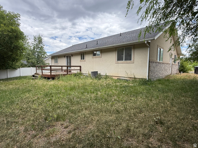 838 East Mountain Road Logan, UT 84321 - Photo 35 of 37 Rear exterior featuring a wood deck, sliding glass door, and multiple windows
