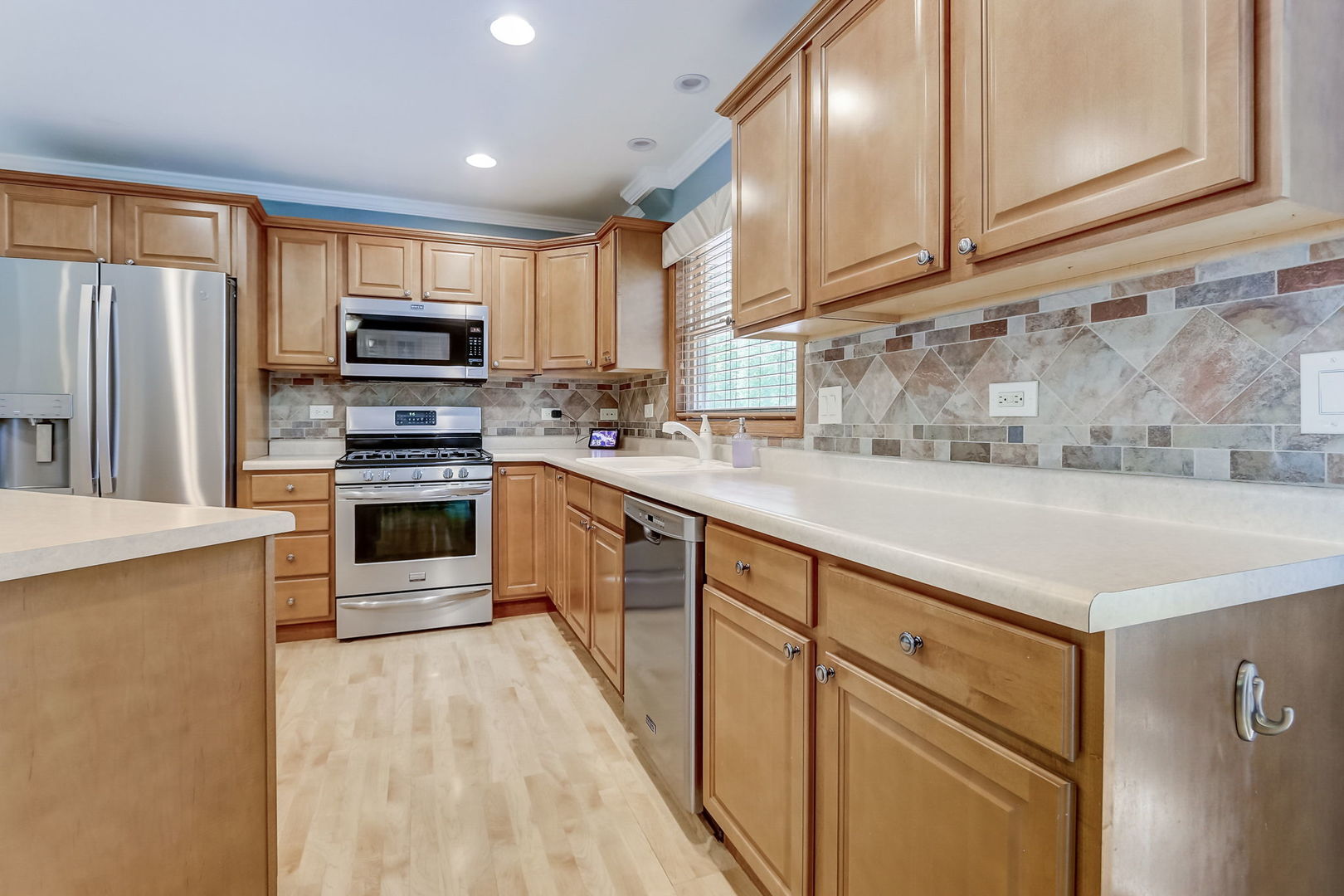 875 Harrison Lane Hoffman Estates, IL 60192 - Photo 10 of 31 a kitchen with stainless steel appliances granite countertop a refrigerator sink and stove
