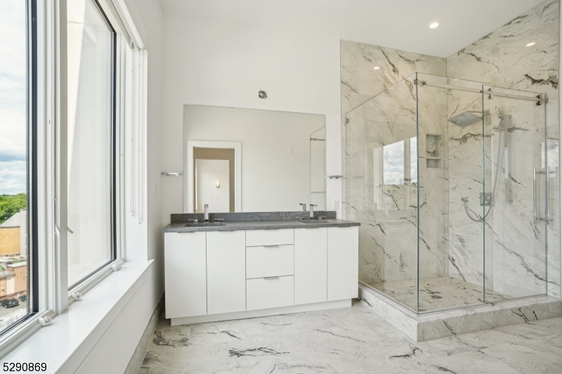 620 Bloomfield Avenue, Unit PHD Bloomfield, NJ 07003 - Photo 13 of 24 a bathroom with a granite countertop sink a mirror and shower