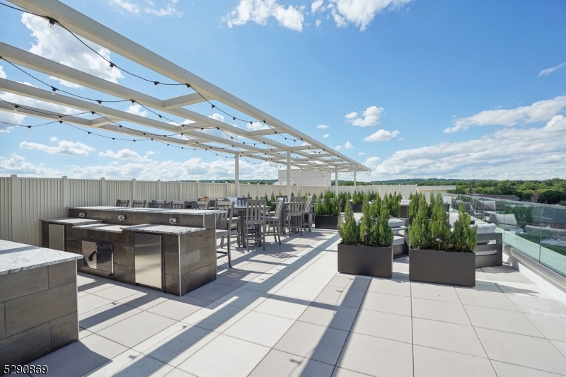 620 Bloomfield Avenue, Unit PHD Bloomfield, NJ 07003 - Photo 20 of 24 a view of a patio with a dining table and chairs