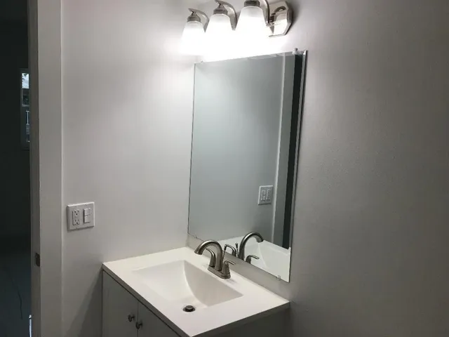 a close view of a sink and a toilet in a bathroom