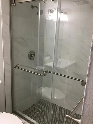 a bathroom with a toilet and a shower